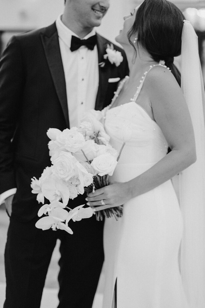 high-end bride and groom with white bouquet