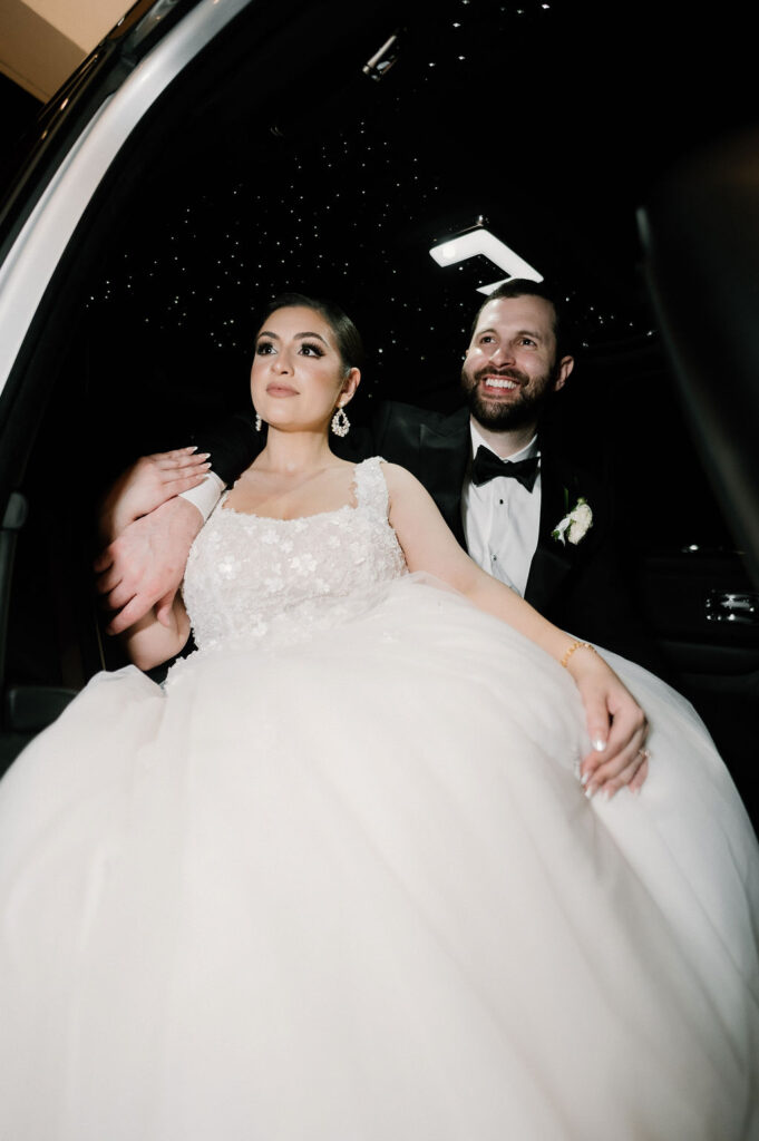 bride and groom in getaway car